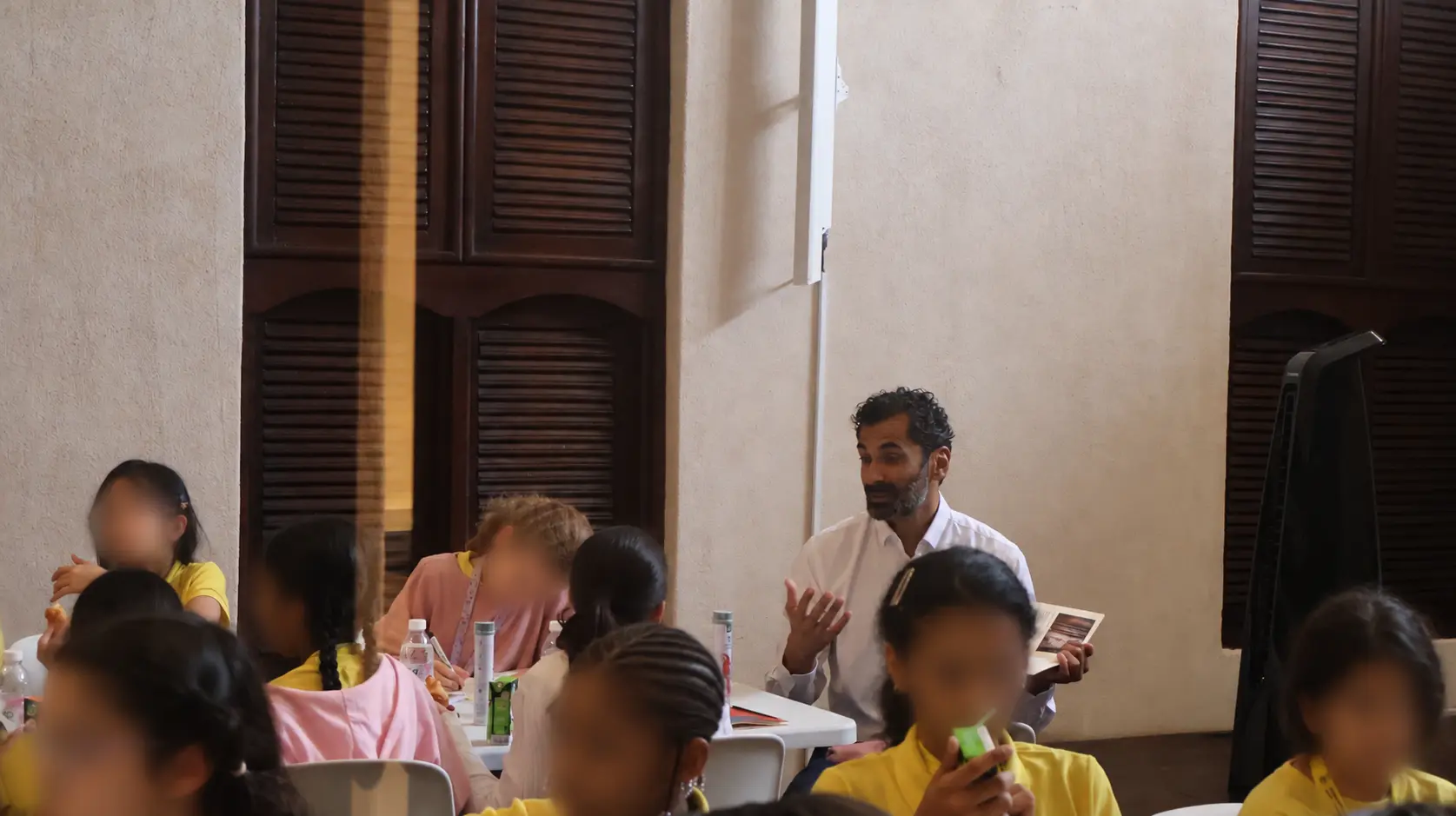 Reading aloud to a group of children during the museum storytelling session