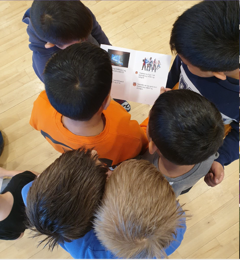 Children gathered around a printed book they created together