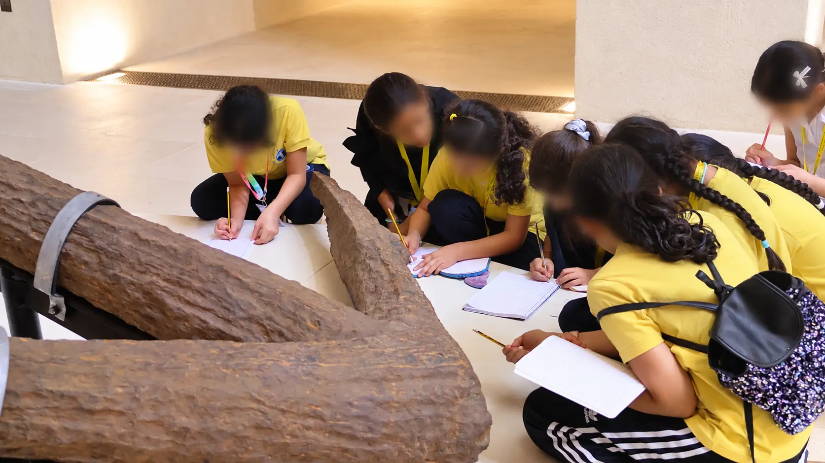A child taking notes next to a museum display about Red Sea marine life