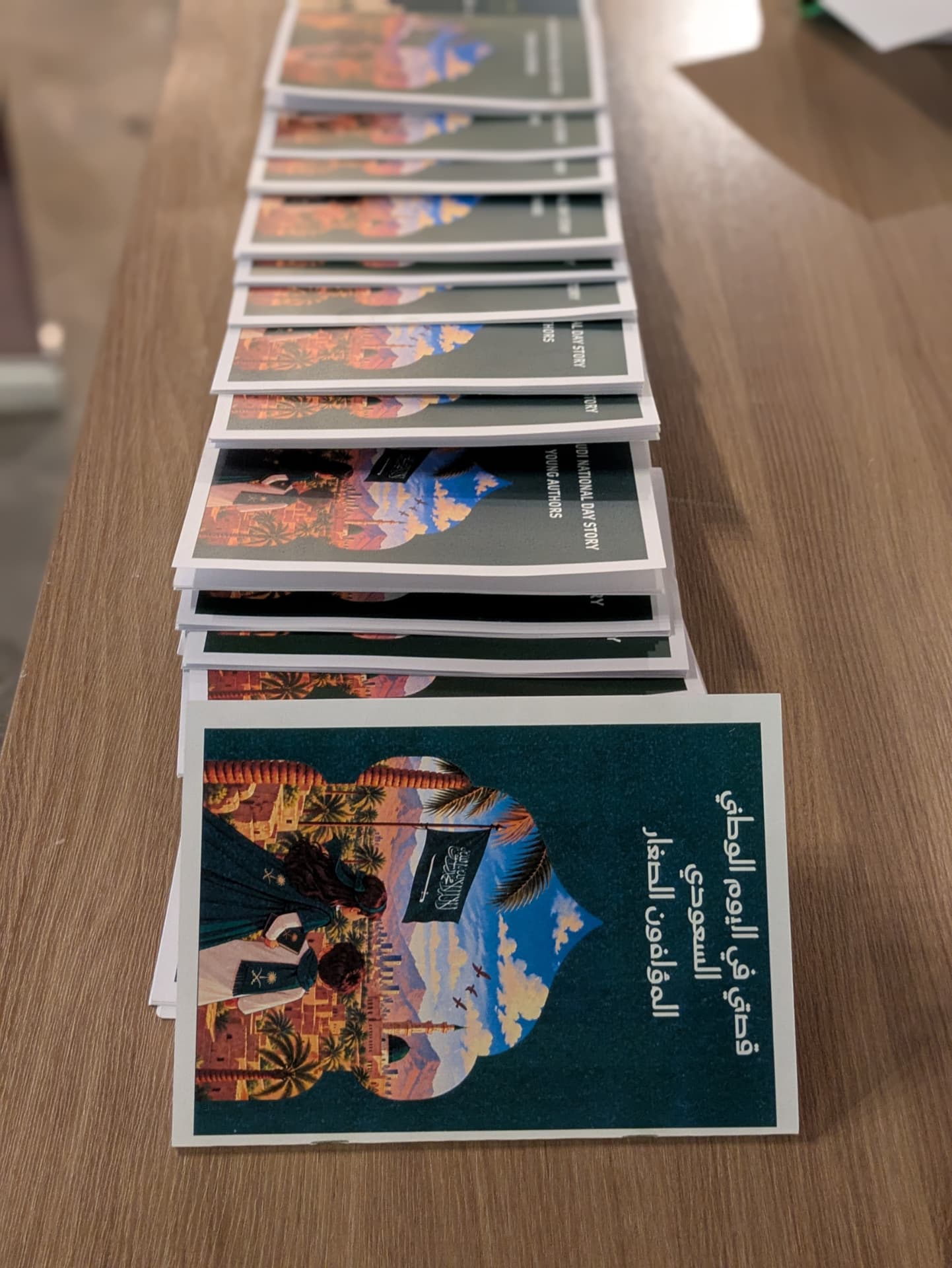 A stack of printed storytelling booklets ready for children at the Al Madinah activation